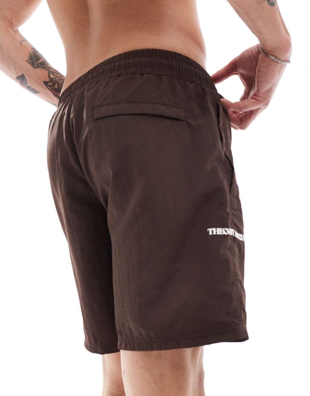 The Couture Club script print swim shorts in brown Product Image