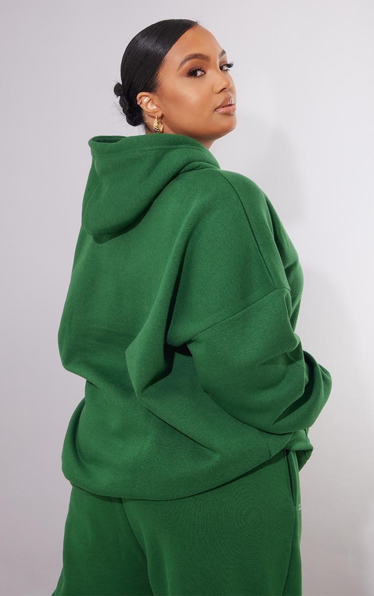 PRETTYLITTLETHING Plus Forest Green Est 2012 Printed Oversized Hoodie Product Image