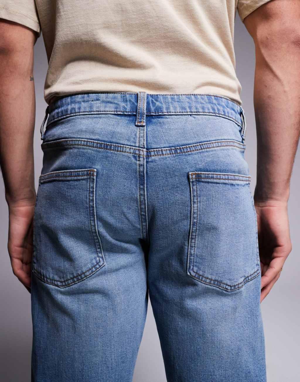 ASOS DSIGN stretch tapered jeans in mid wash with vintage tint Product Image