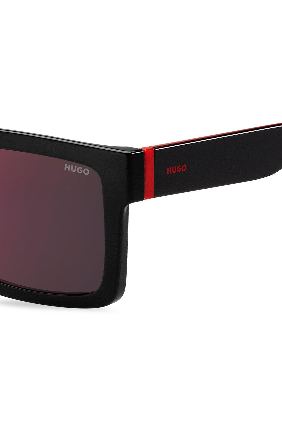 Black sunglasses with signature red accents Product Image