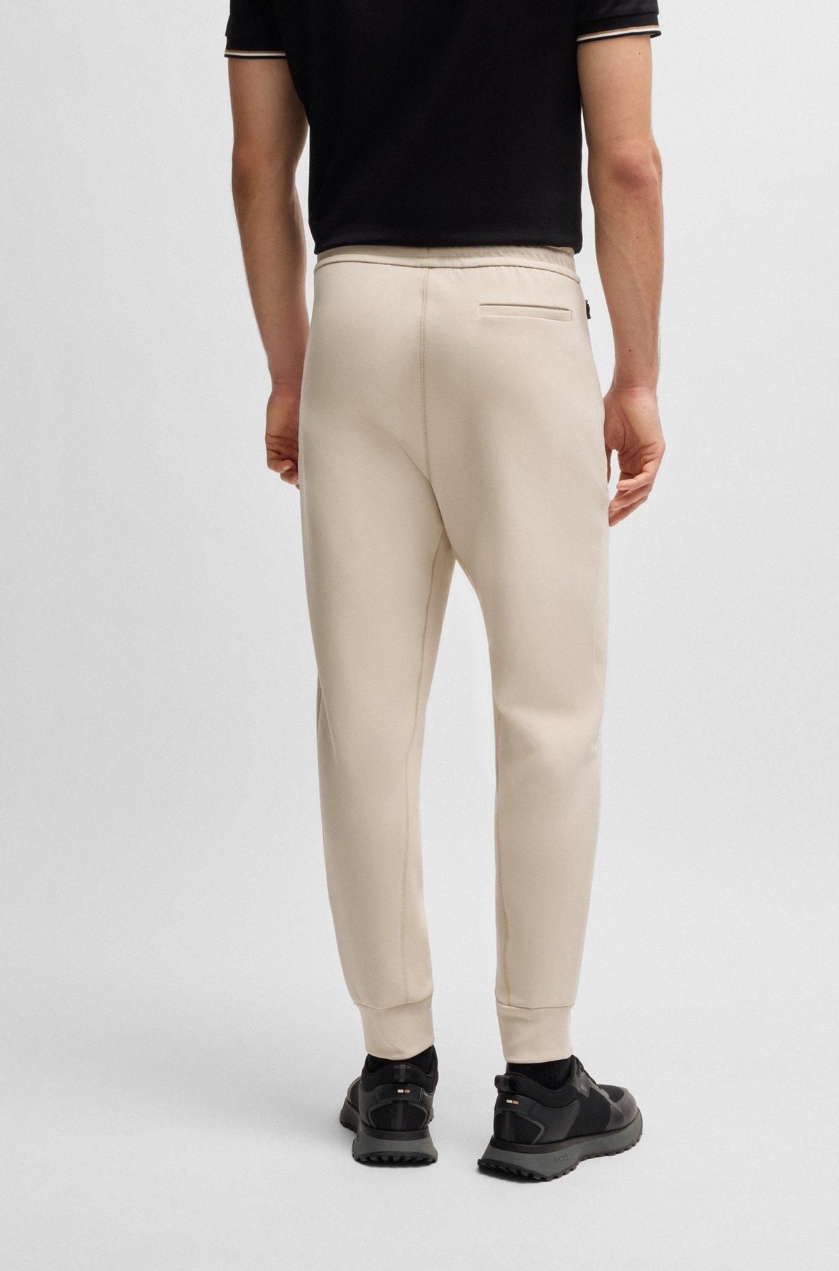Stretch tracksuit bottoms with logo patch Product Image