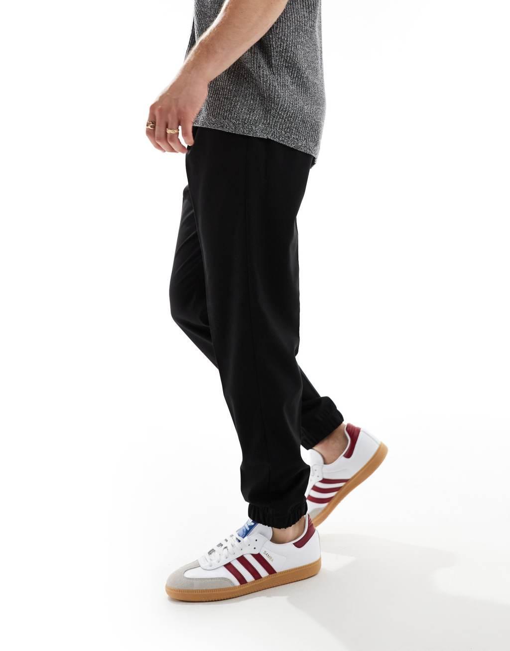 ASOS DESIGN tapered smart pants with sweatpants cuff in black Product Image