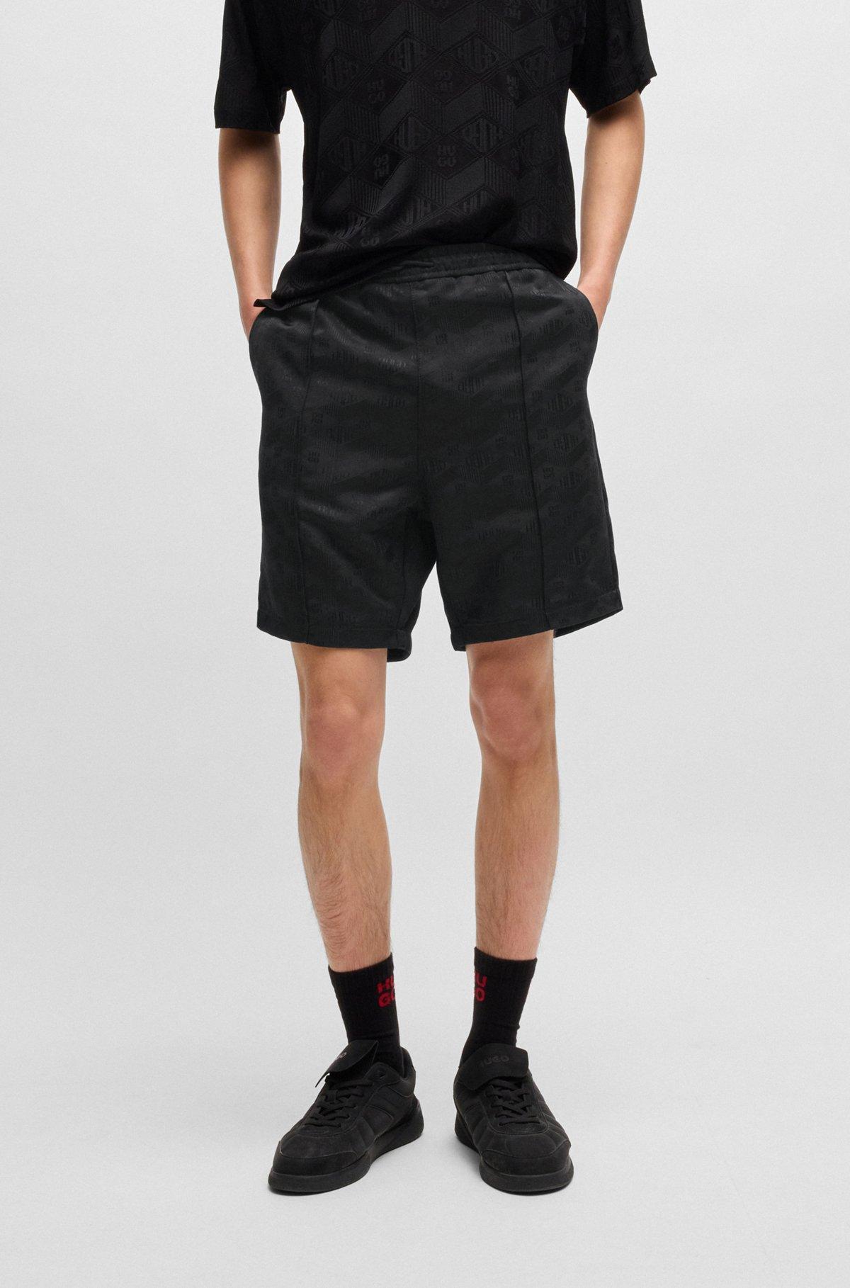 Relaxed-fit shorts with geometric logos Product Image