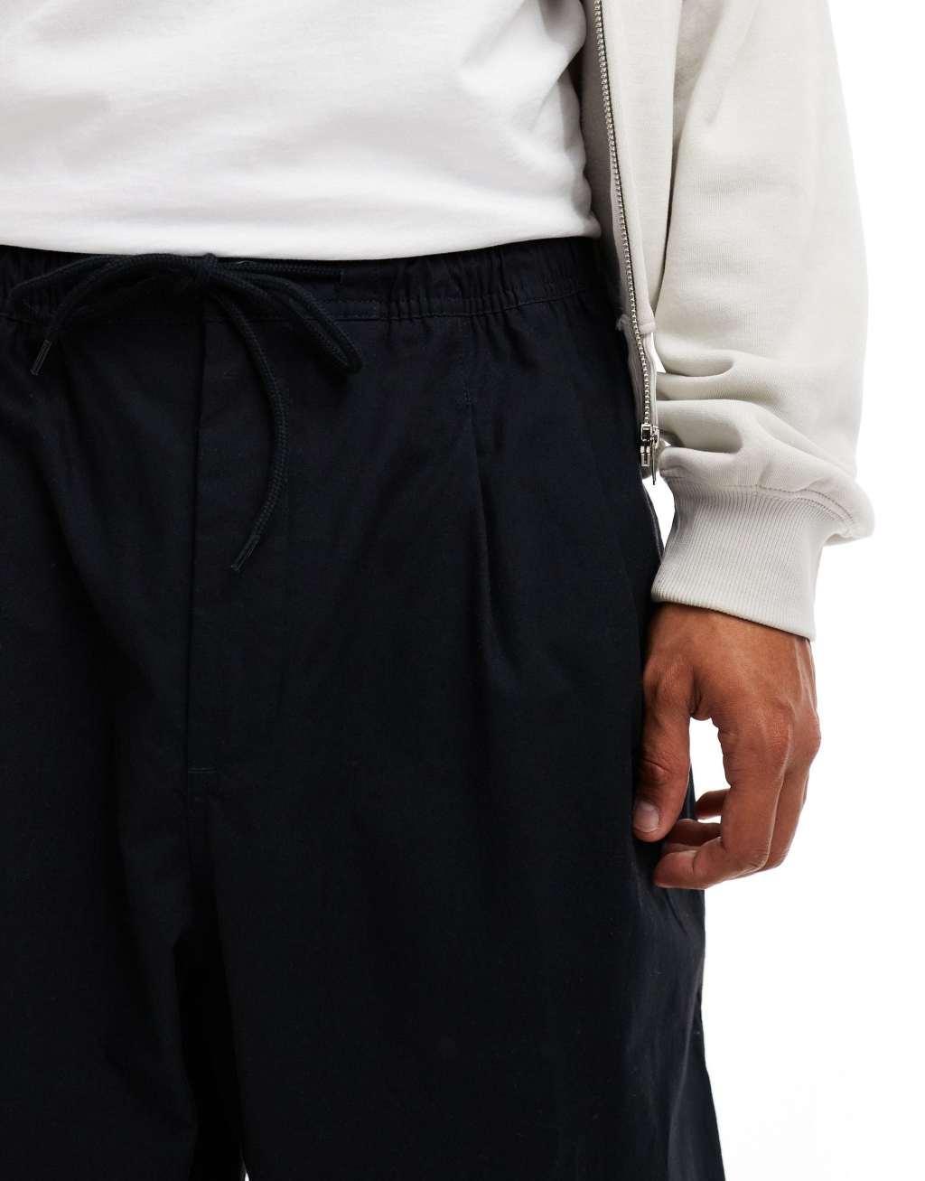 Nike Club woven balloon pants in black Product Image