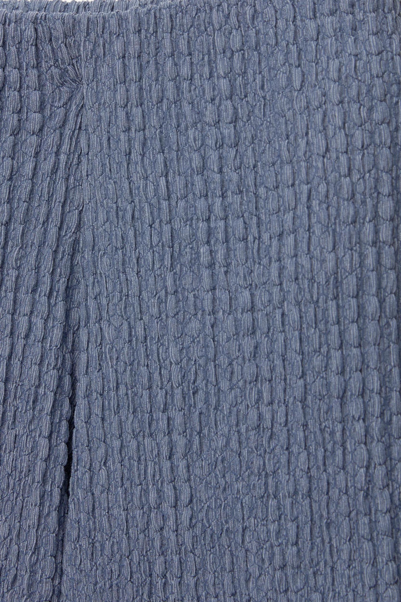 Rustic creased-effect pants Product Image