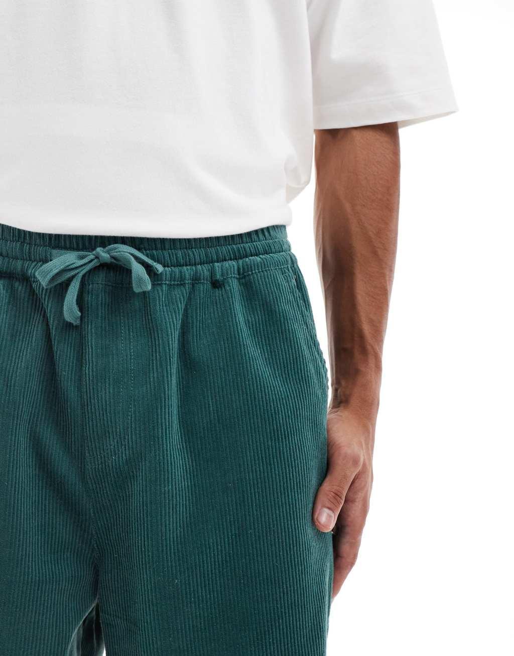 ASOS DESIGN tapered cord pants in green Product Image