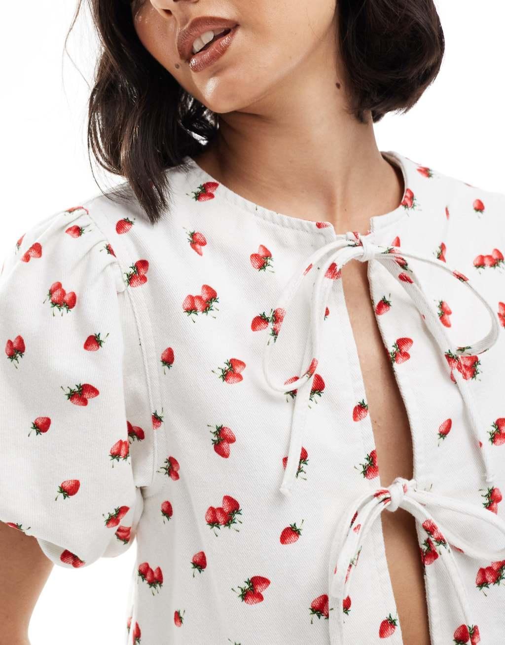 ASOS DESIGN denim puff sleeve tie front top in strawberry print Product Image