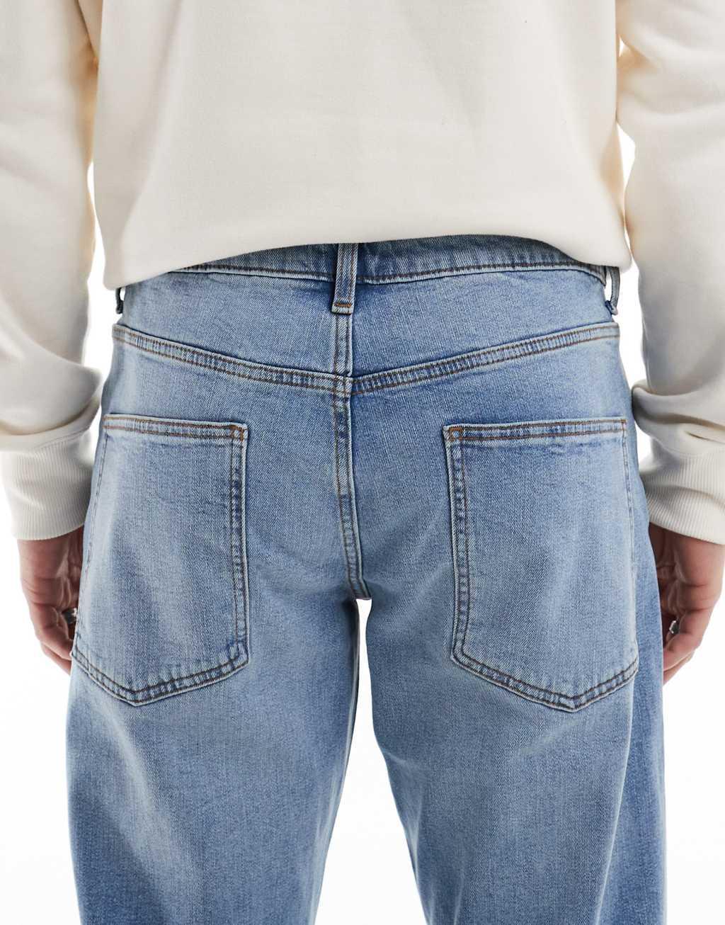 ASOS DESIGN stretch tapered jeans in light wash Product Image