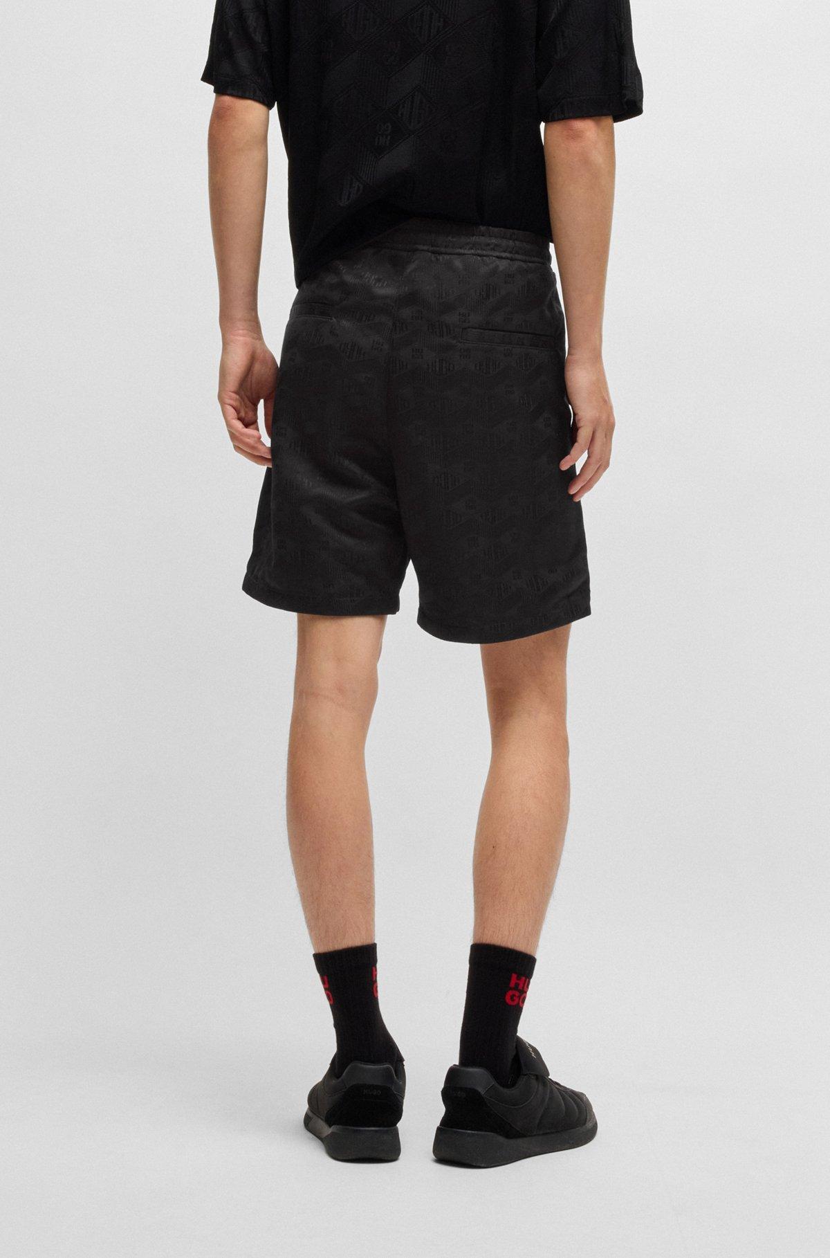 Relaxed-fit shorts with geometric logos Product Image