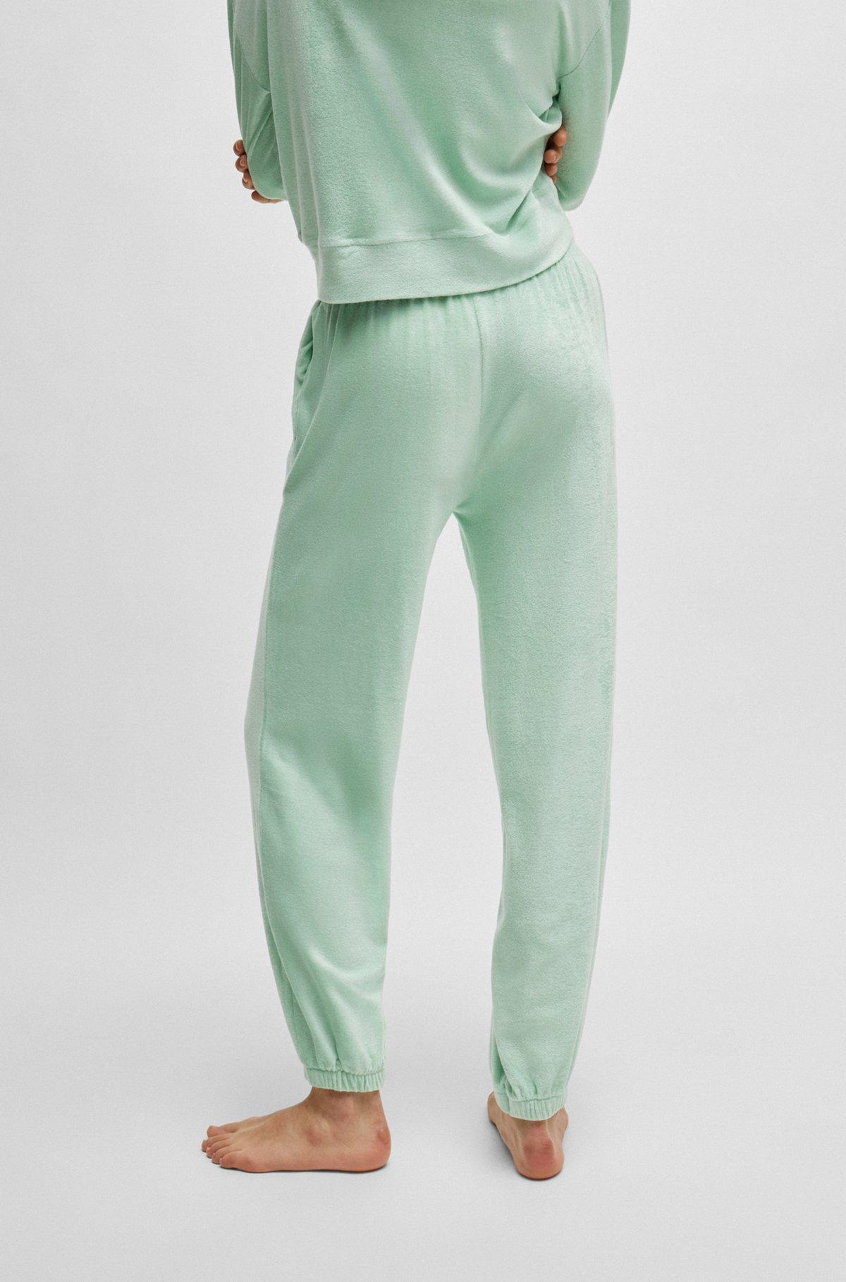 Cuffed tracksuit bottoms in terry fabric with handwritten logo Product Image