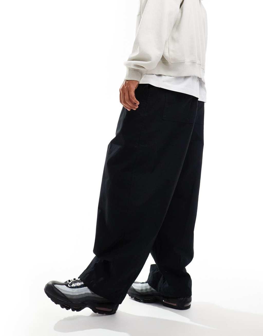 Nike Club woven balloon pants in black Product Image