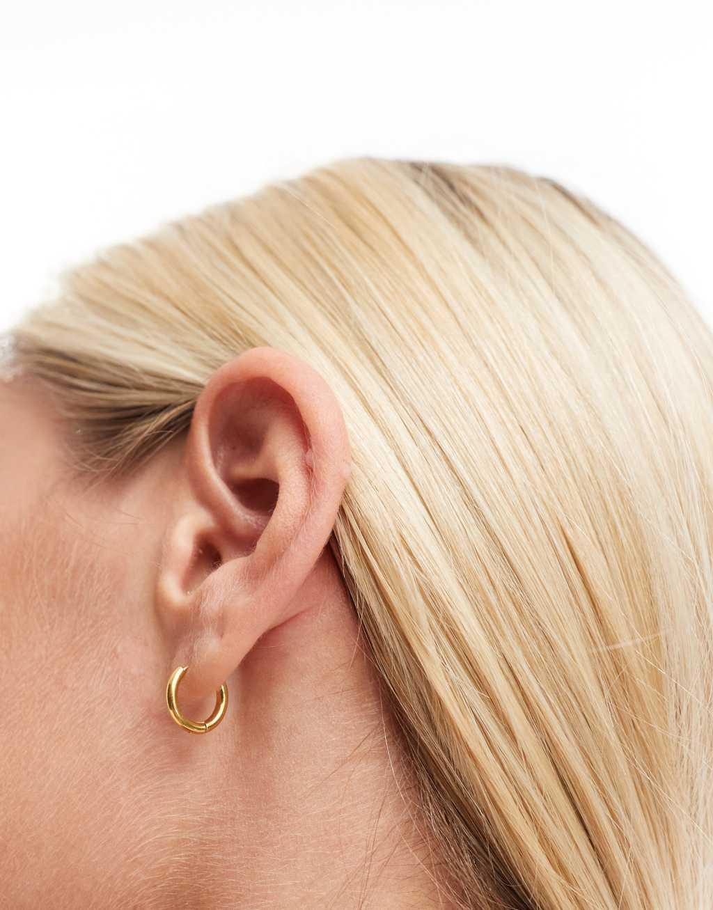 ASOS DESIGN waterproof stainless steel huggie hoop earrings in gold tone Product Image