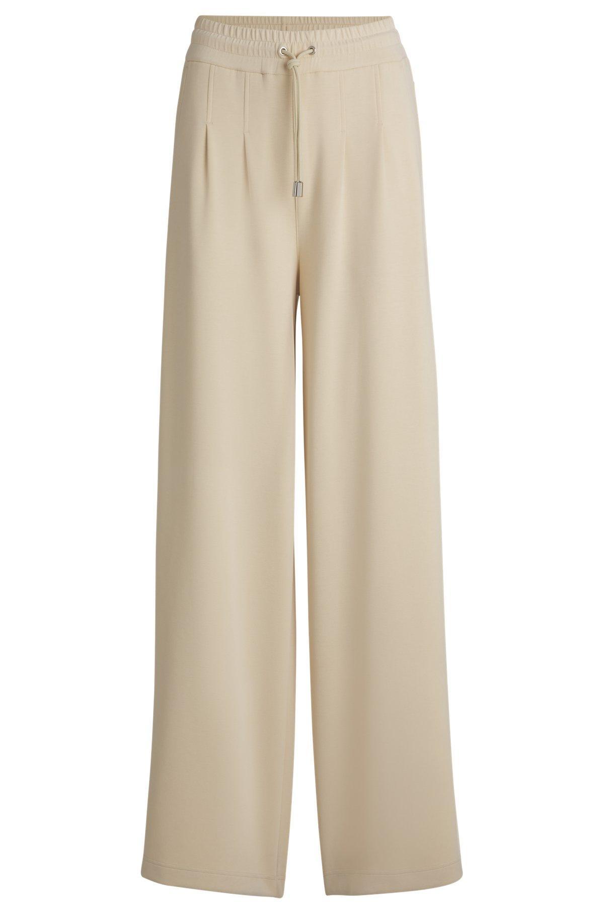 Wide-leg tracksuit bottoms with pleat details Product Image