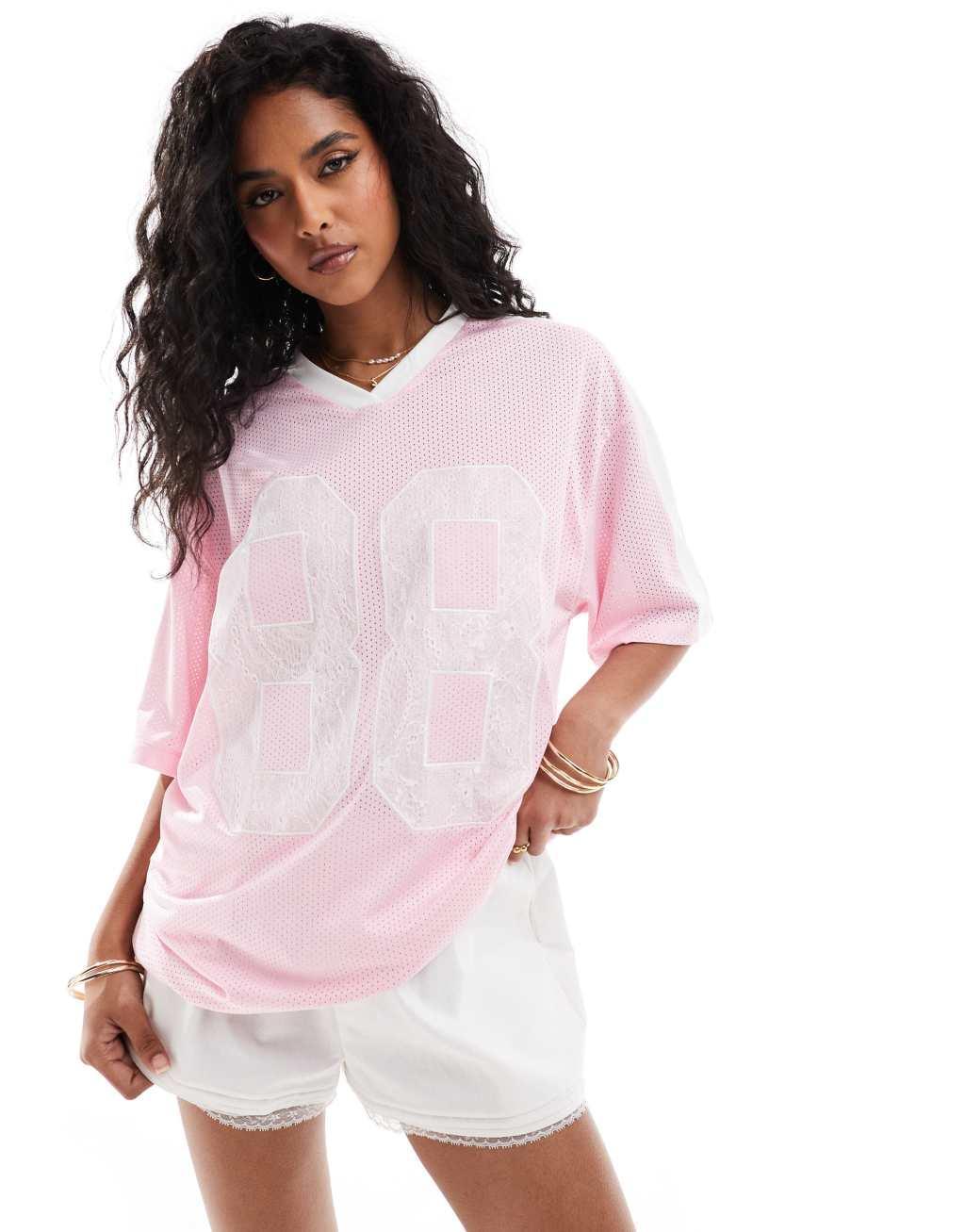 ASOS DESIGN oversized v-neck football t-shirt with lace numbers in pink Product Image