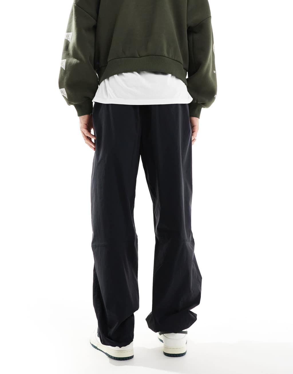 Nike Tech Woven oversized pants in black Product Image