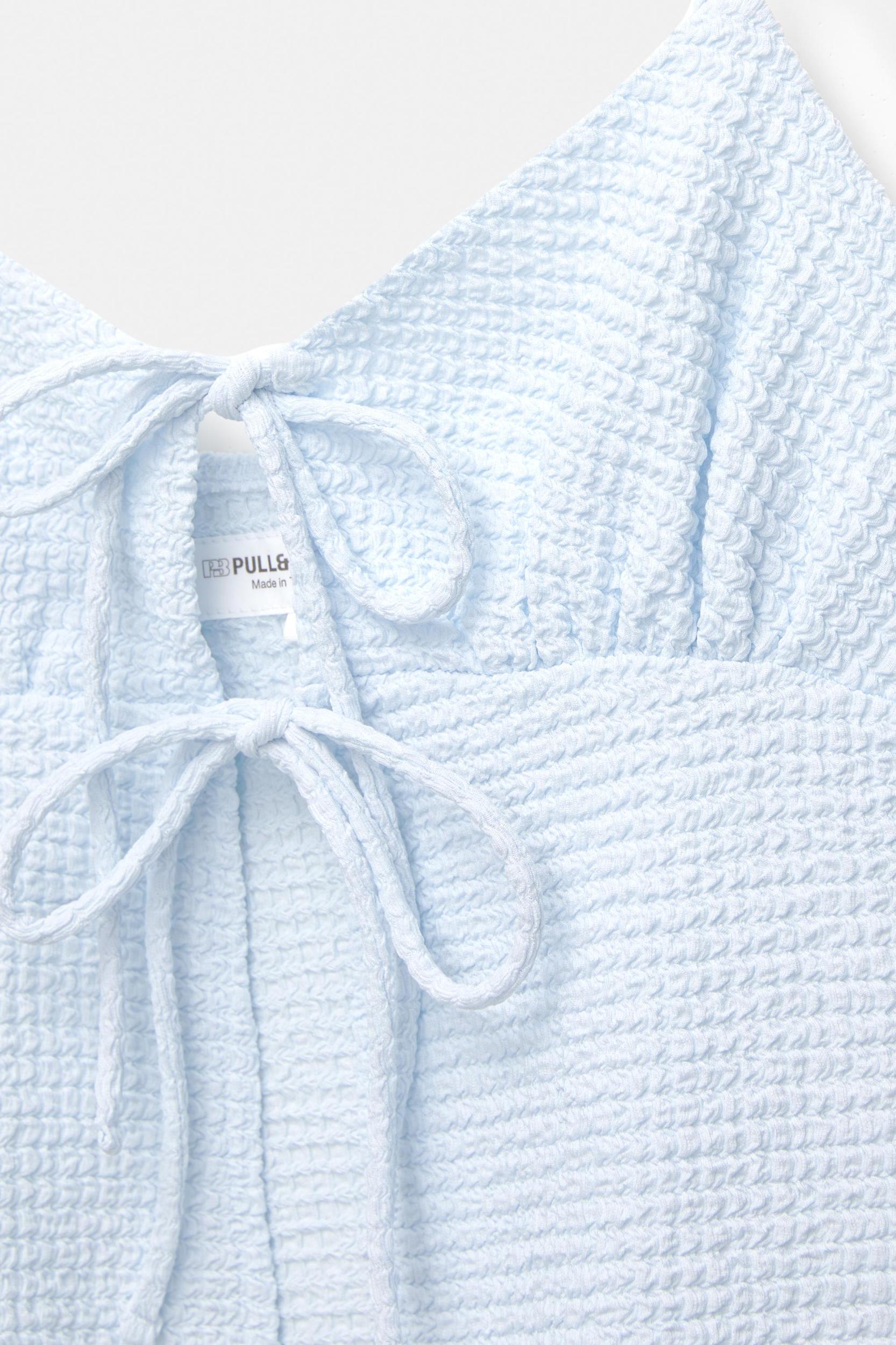 Creased-effect top with bows Product Image