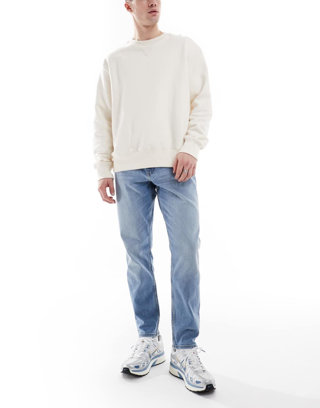 ASOS DESIGN stretch tapered jeans in light wash Product Image