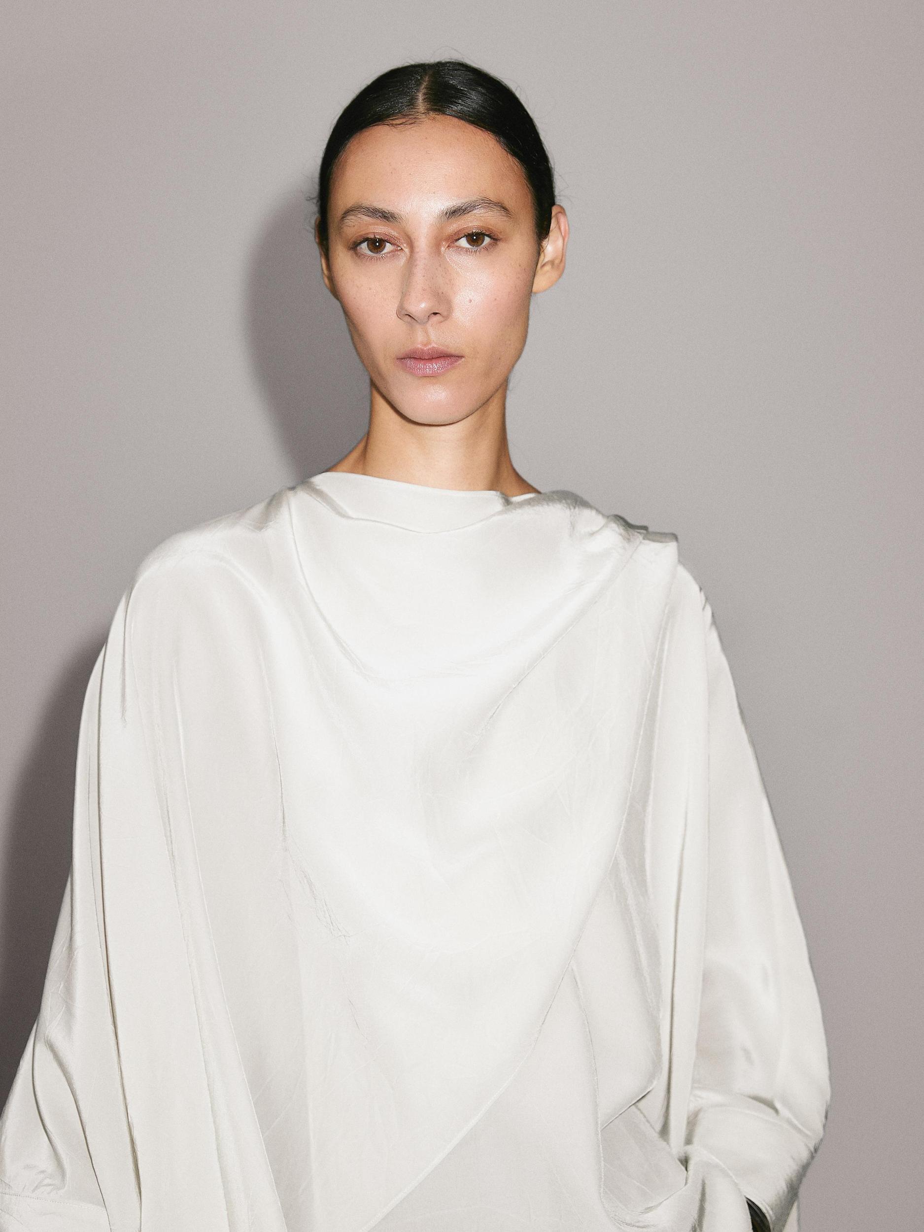 Short flowing cape with sleeve detail Product Image