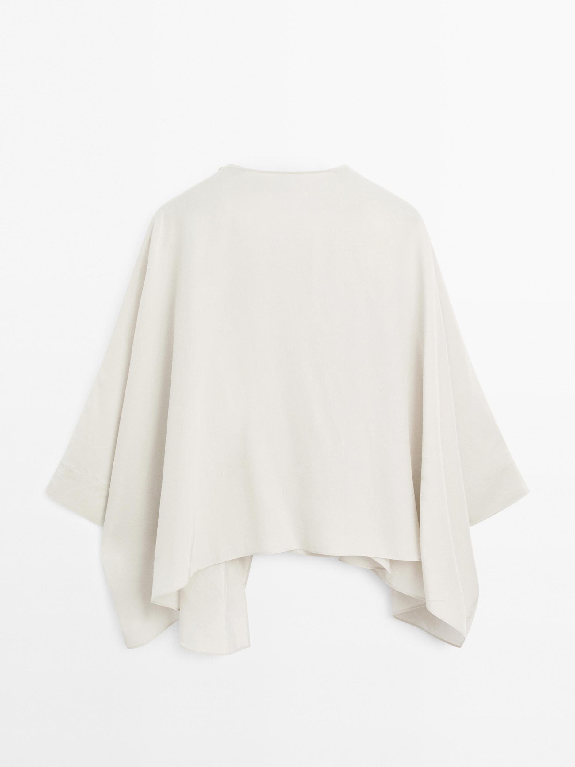 Short flowing cape with sleeve detail Product Image