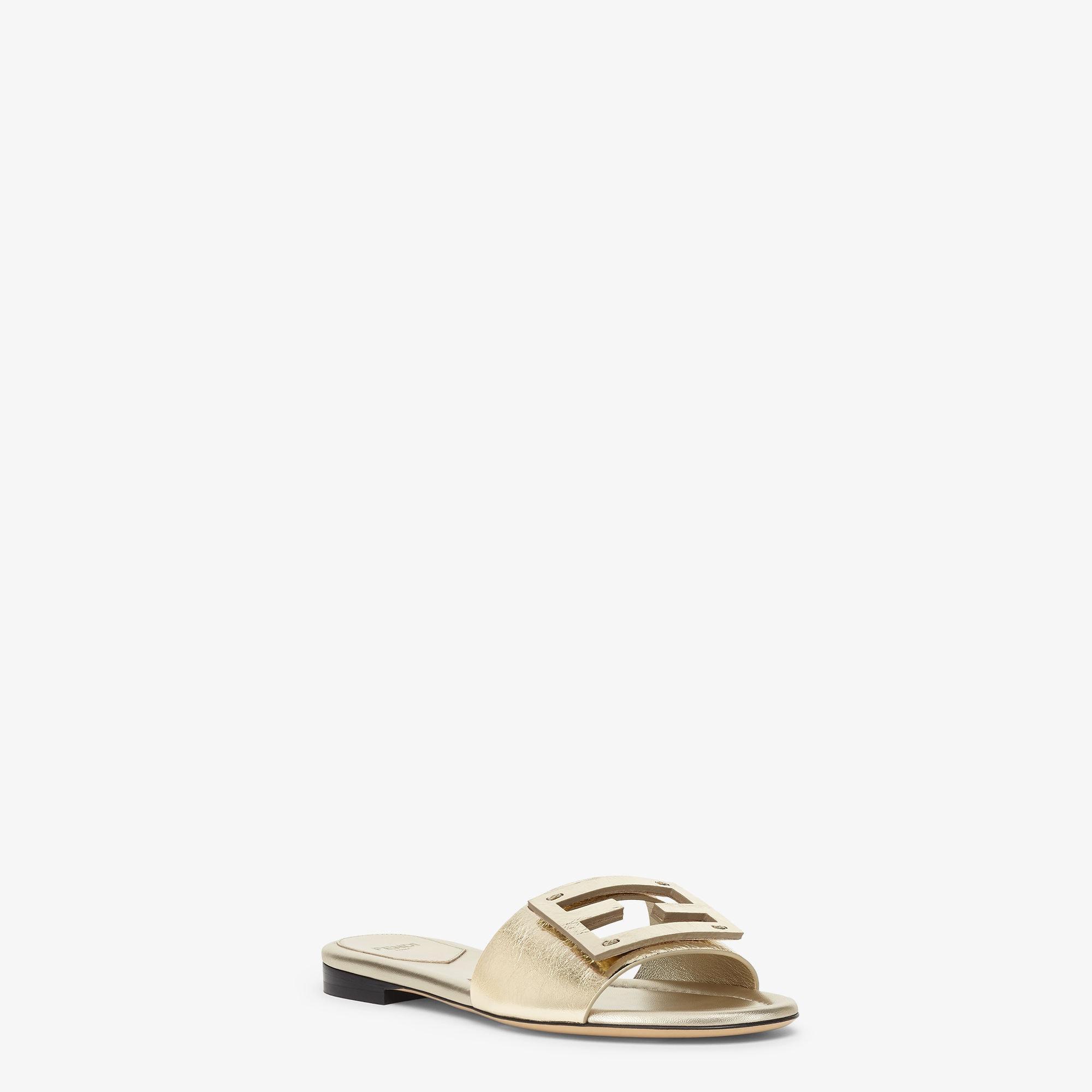 BaguetteMetallic champagne-colored leather slides Product Image