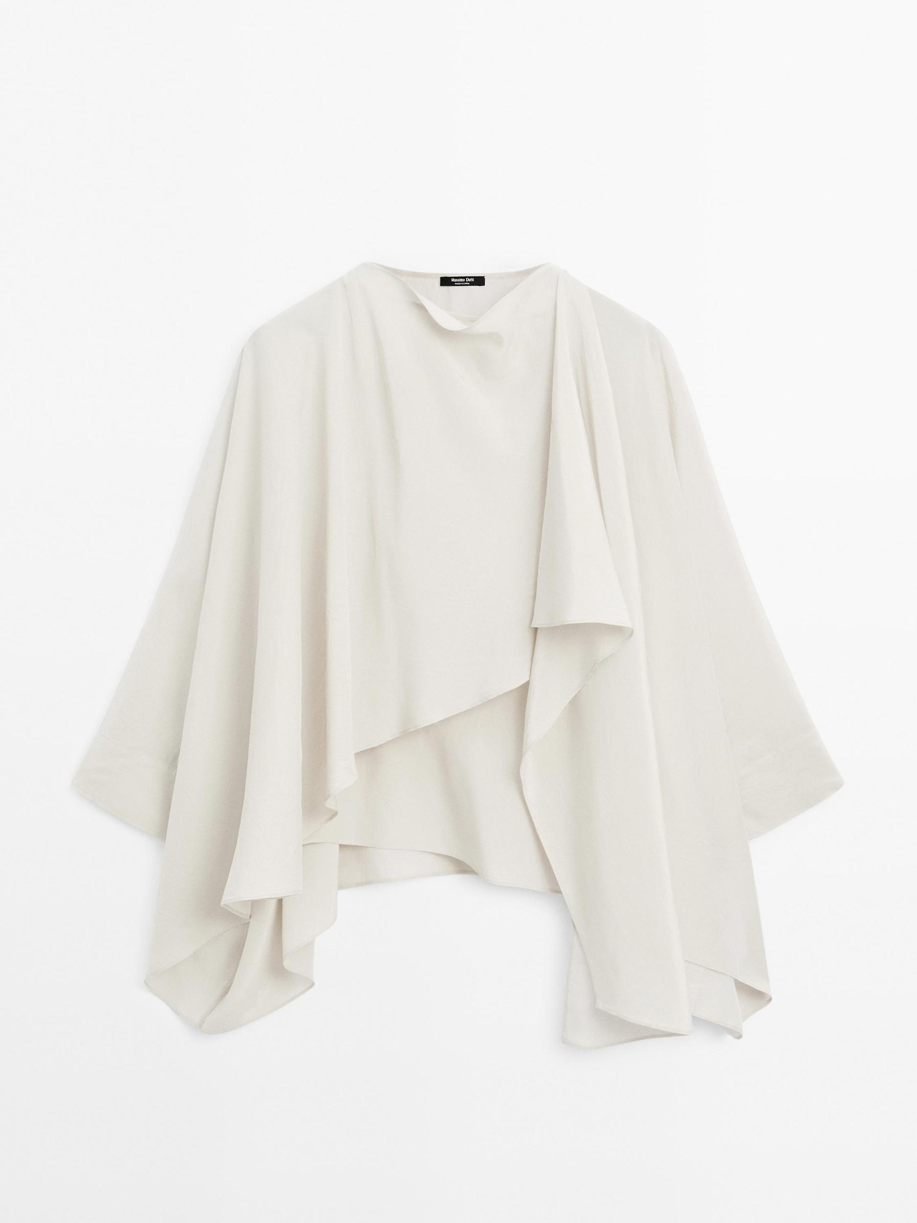 Short flowing cape with sleeve detail Product Image