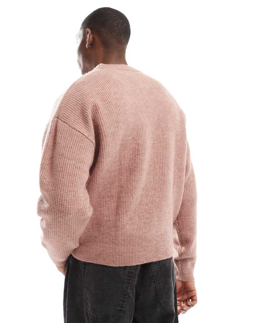 Bershka knitted embroidered sweater in pink Product Image