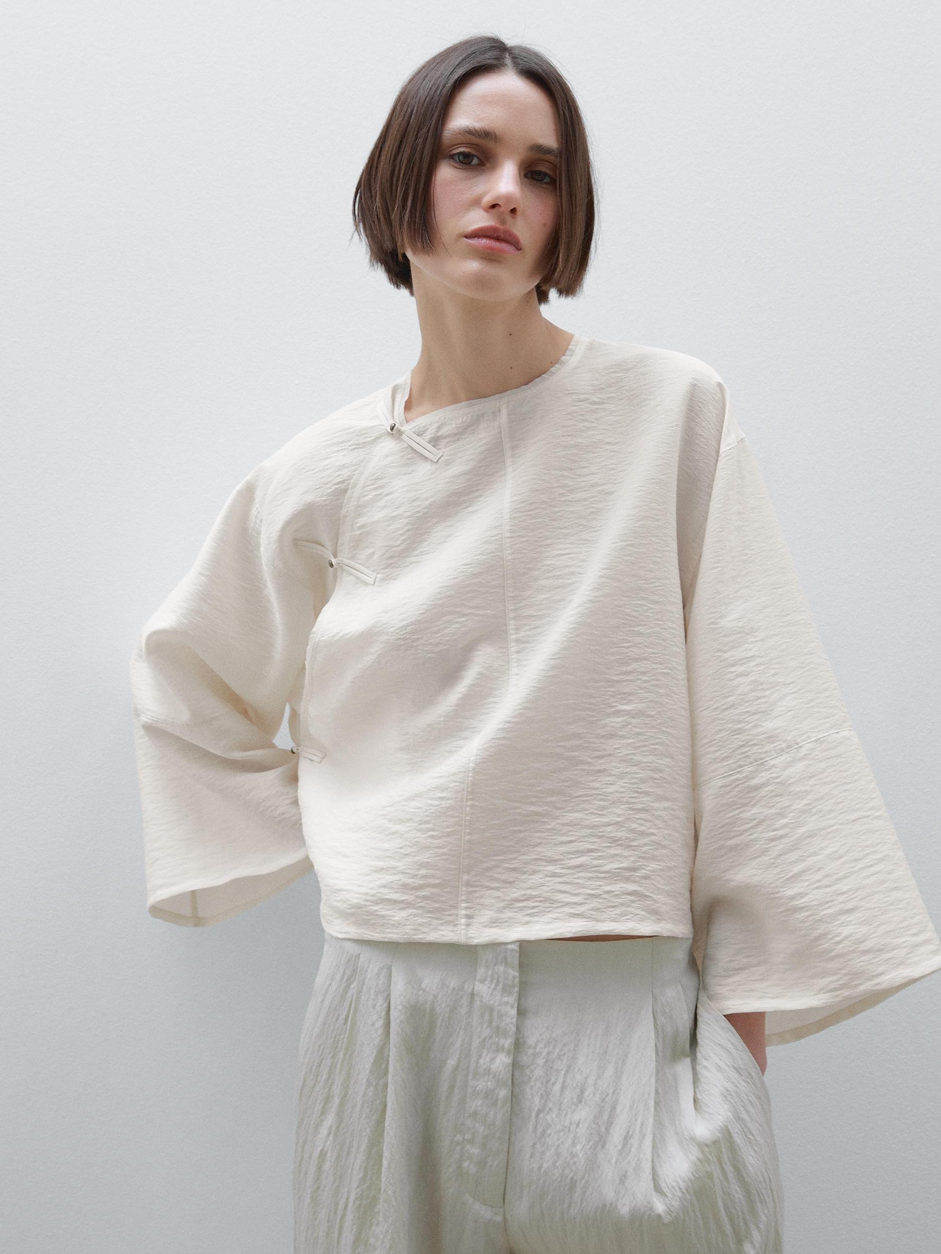 Short flowing blouse with button detail Product Image