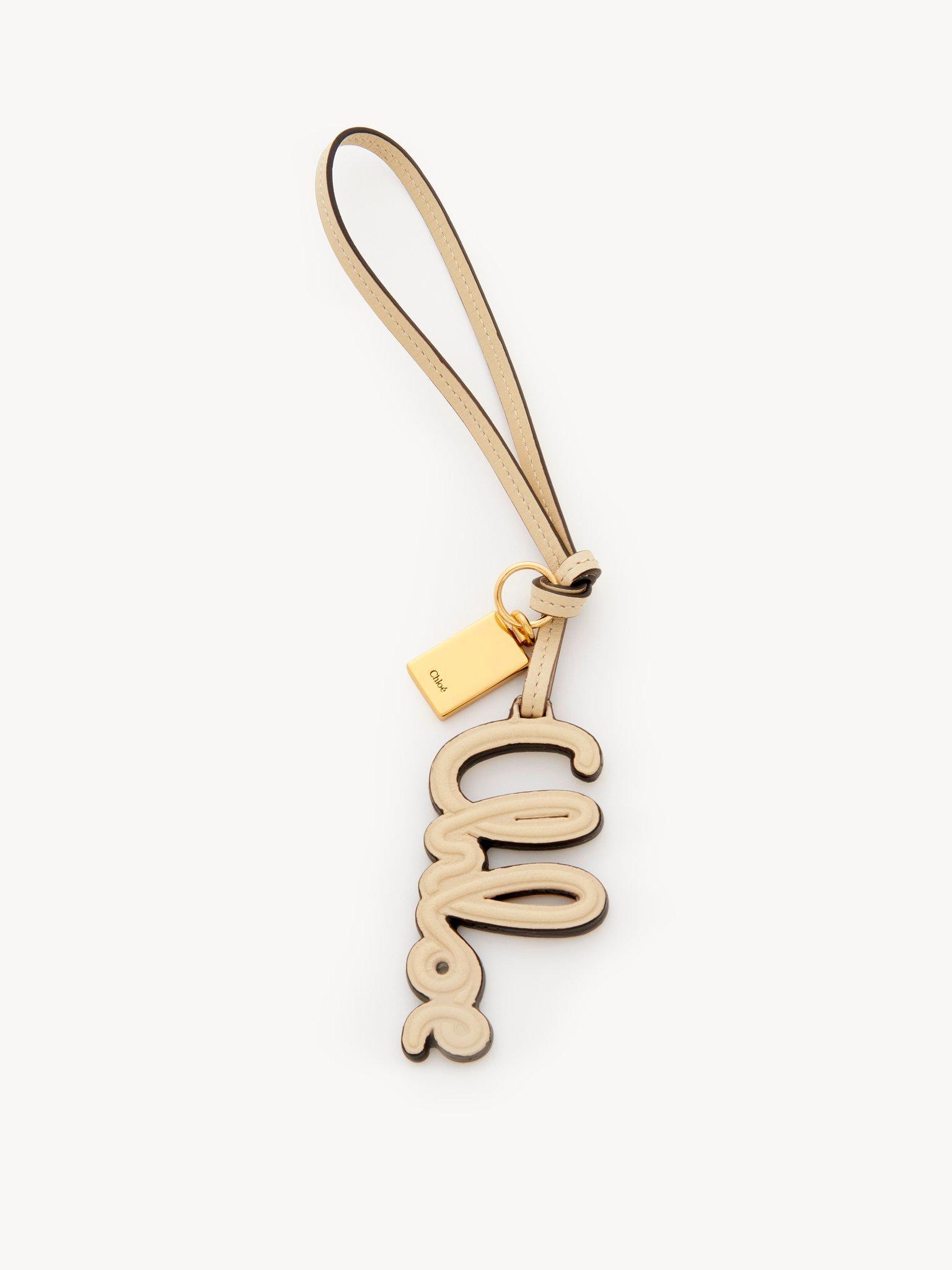 Logo bag charm in shiny leather Product Image