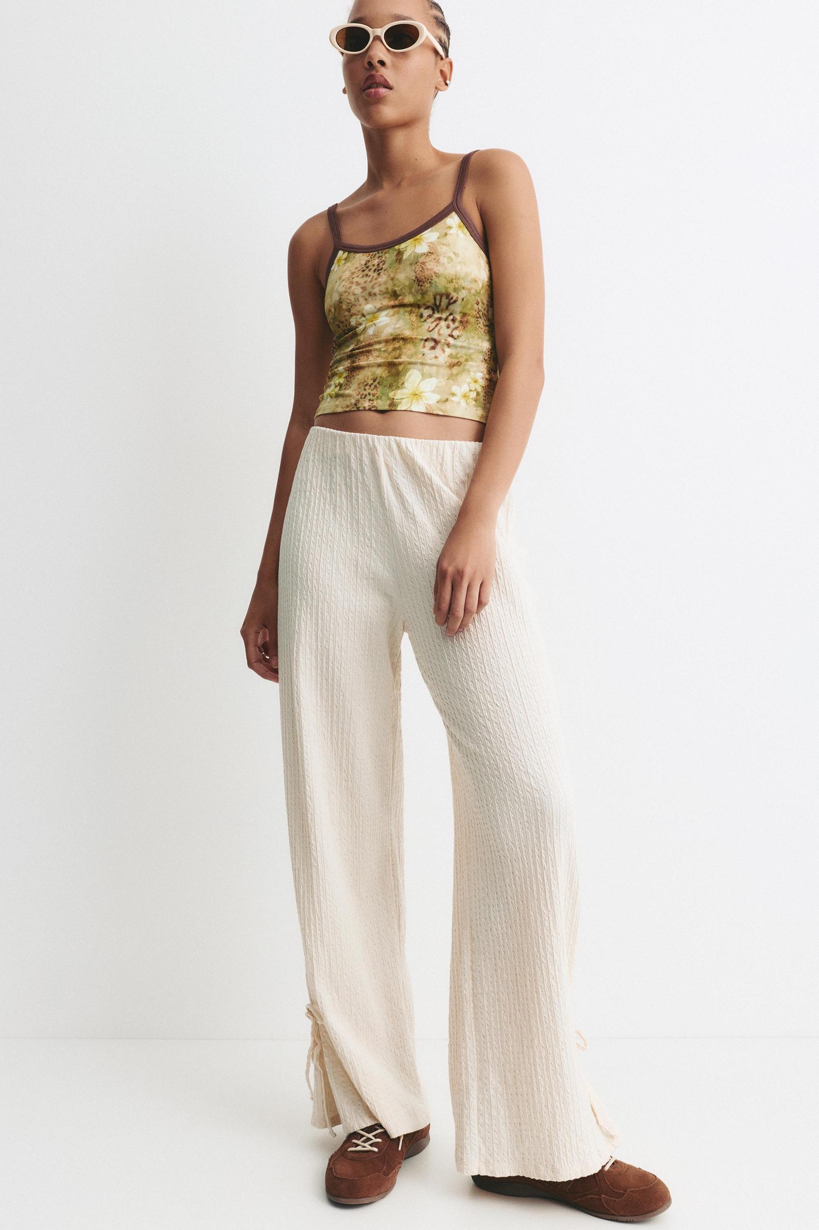 Rustic trousers with knot detail Product Image