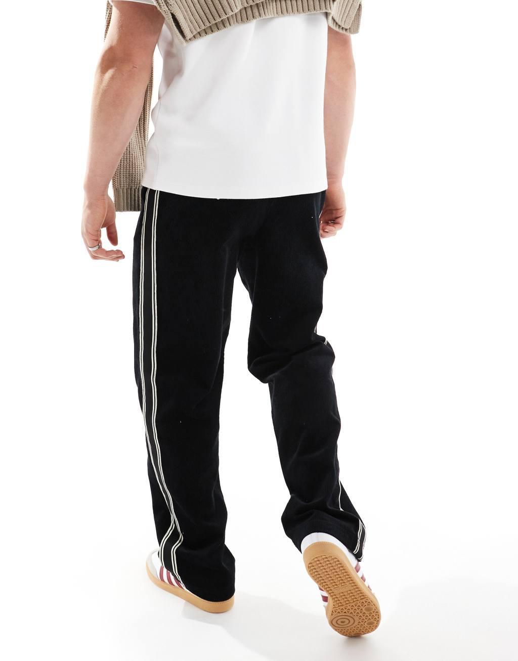 ASOS DESIGN baggy cord pants with side taping in black  Product Image