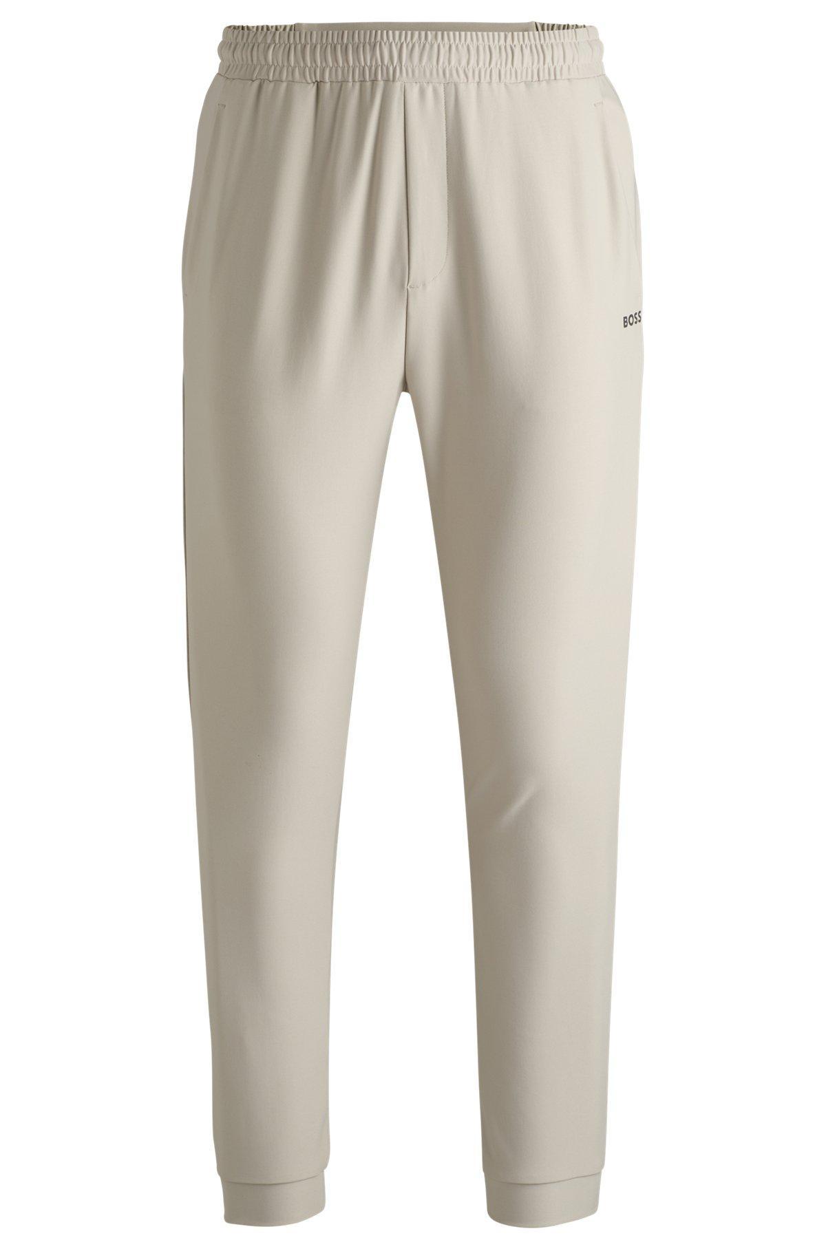 Tracksuit bottoms in stretch fabric with decorative reflective logo Product Image