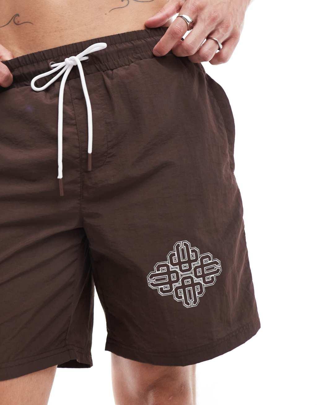 The Couture Club script print swim shorts in brown Product Image